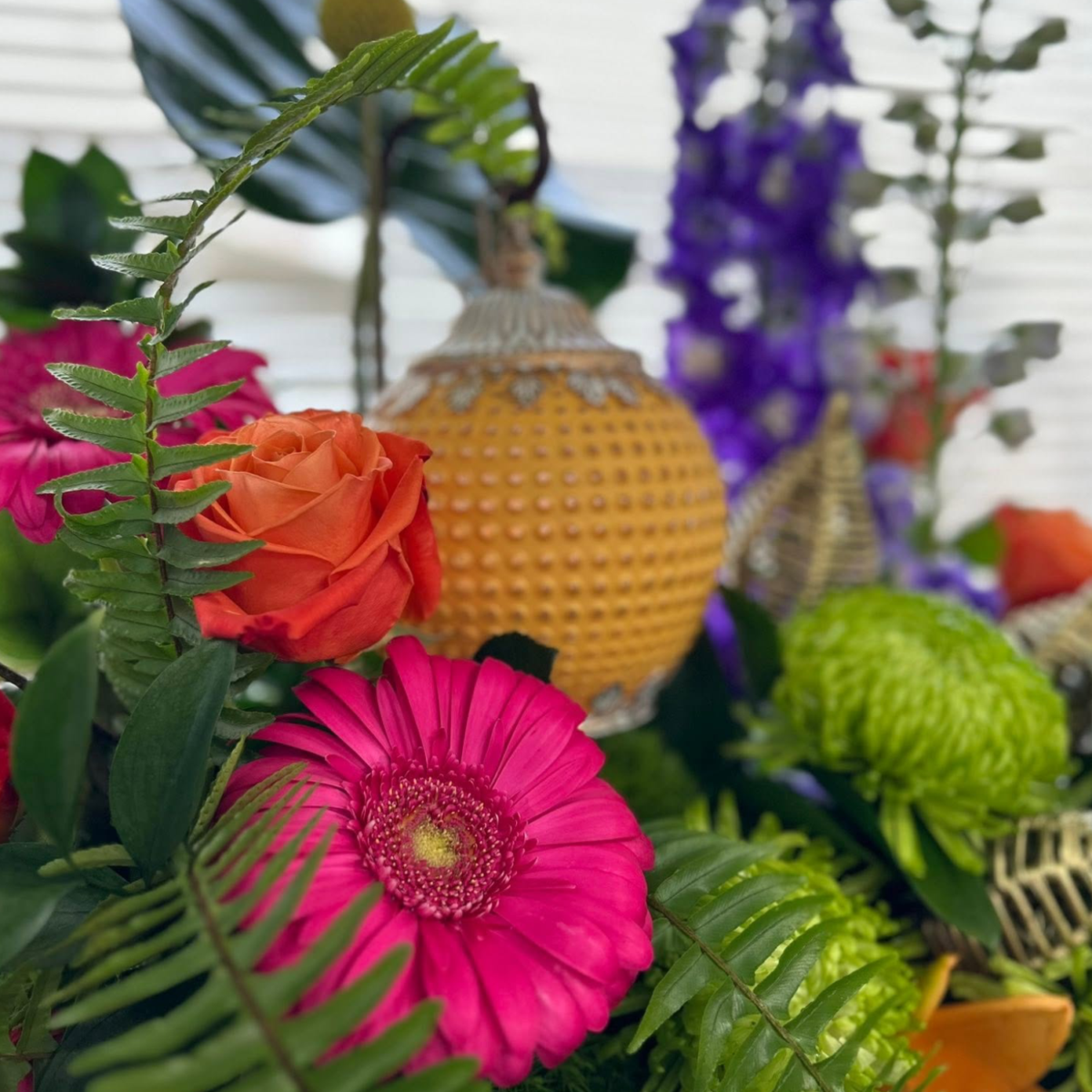 Colourful flowers with sprigs of fern