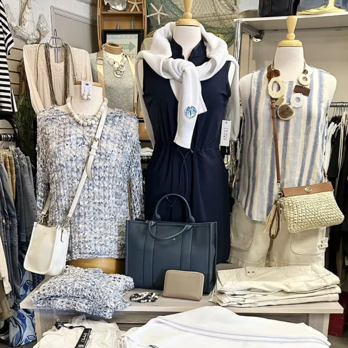 three mannequins with trendy outfits for middle aged women