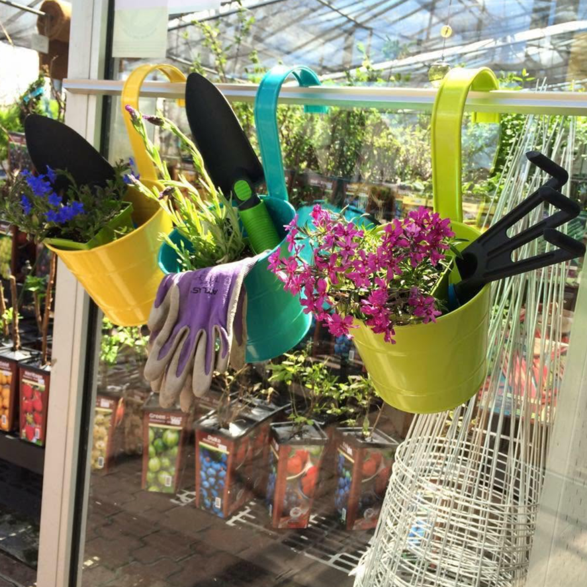 3 colourful storage baskets holding gardening supplies