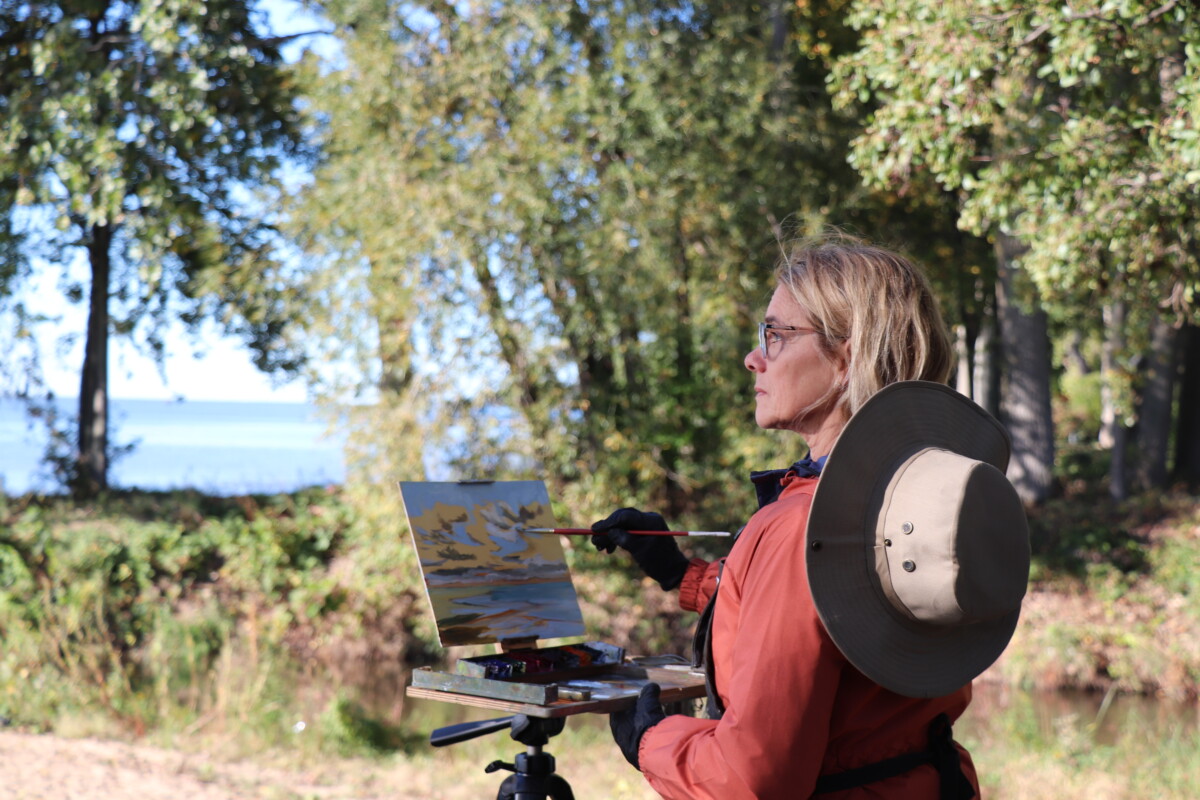 En plein air artist paints an outdoor scene
